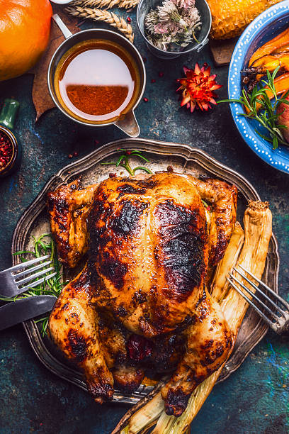 istock Baked whole chicken with sauce and roasted vegetables 615089136