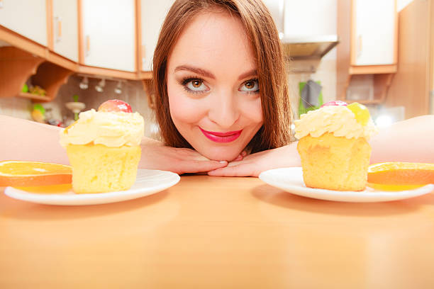 istock Woman looking at delicious sweet cake. Gluttony. 615090968