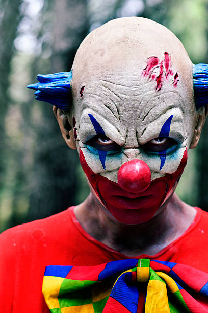 istock scary evil clown in the woods 615091128