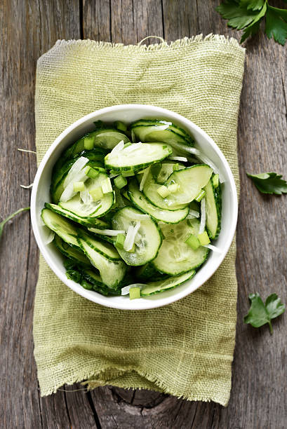 istock Cucumber salad in bowl, top view 615091658
