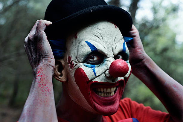 istock scary evil clown in the woods 615091750