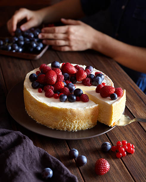 homemade creamy mascarpone new york cheesecake with berries on dark - raspberry table wood autumn imagens e fotografias de stock