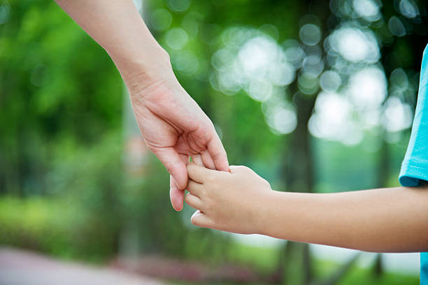 istock Mother and son holding hands 615092360