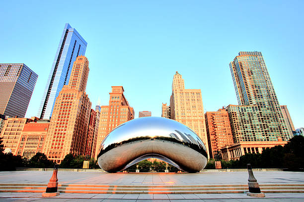 Cloud Gate in Millennium Park at Sunrise, Chicago Chicago, United States - September 3, 2015: Cloud Gate in Millennium Park. The Cloud Gate is a major tourist attraction and a gate to traditional Chicago Jazz Fest. millennium park chicago stock pictures, royalty-free photos & images
