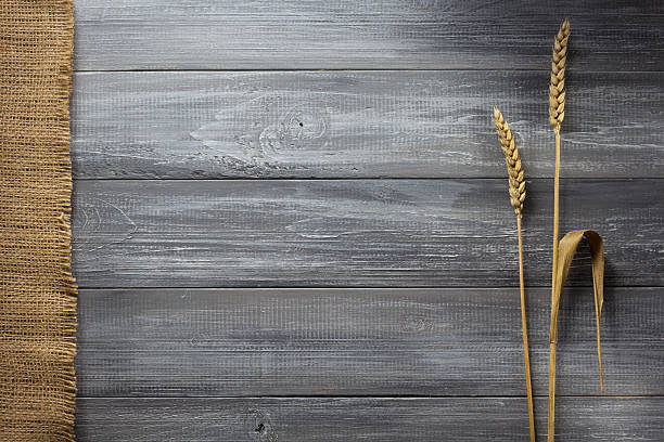 istock ears of wheat on wood 615093928