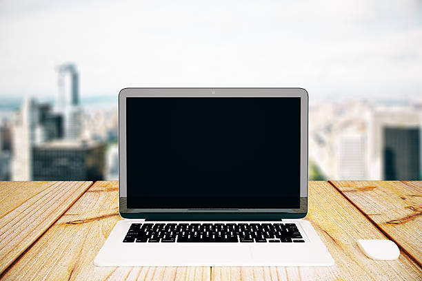 istock Blank laptop on city background 615094212