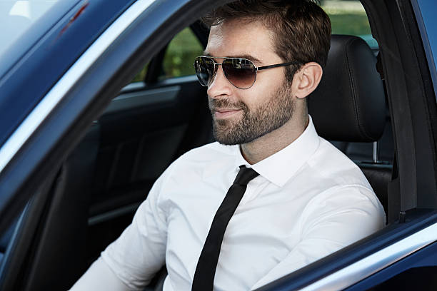 istock Cool businessman in car 615095164