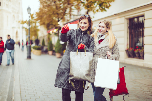 Women, shopping, friendship, city, using phone, autumn, winter, fancy