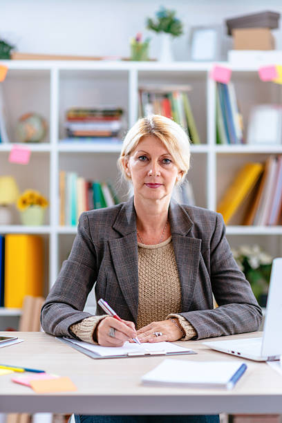 istock Businesswoman in office signing document 615096560