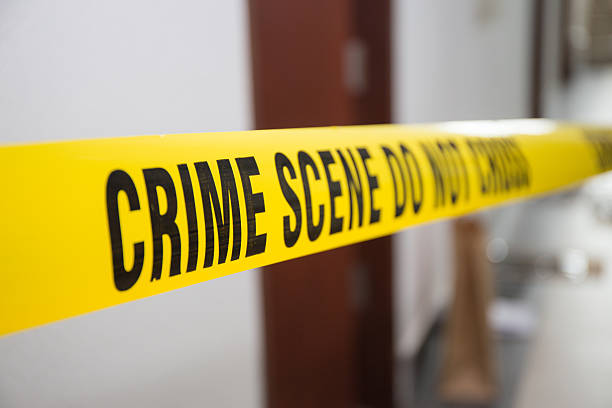 istock crime scene tape in front room door with blurred background 615097508