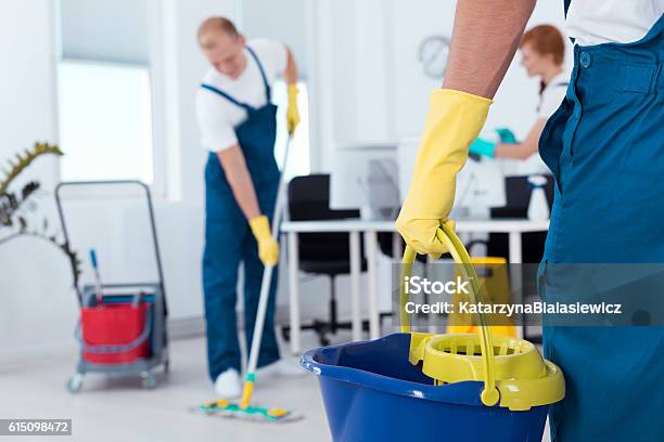Person Holding A Mop Pail Stock Photo - Download Image Now - Cleaning, Business, Cleaner