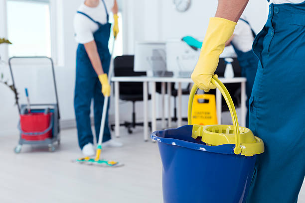 istock Man holding mop bucket 615098480