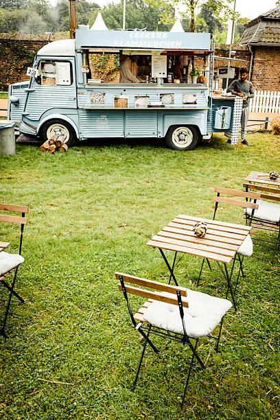 Citroen HY classic panel van food truck in a field Jüchen, Germany - August 5, 2016: Citroen HY classic panel van food truck in a field surrounded by bistro tables and chairs. The car is on display during the 2016 Classic Days at castle Dyck. The car is displayed in a field, with people looking at the cars in the background. citroen hy stock pictures, royalty-free photos & images