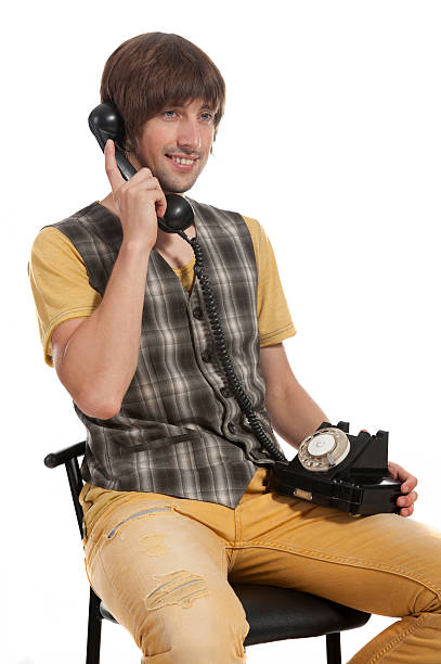 istock young man with an old phone in your hands 615099950