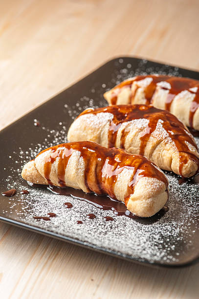 istock Puffs on brown plate with chocolate glaze 615100060