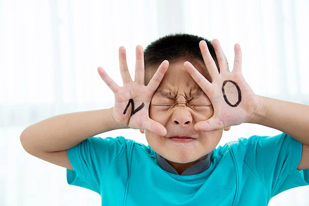 Asian boy makes a stop gesture Asian boy makes a stop gesture. single word no stock pictures, royalty-free photos & images
