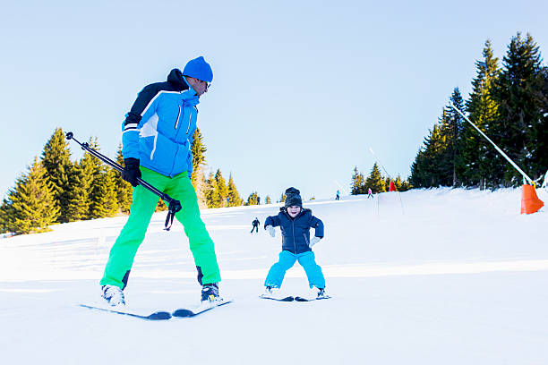 istock Smiling kid skiing downhill at ski slope. 615104252