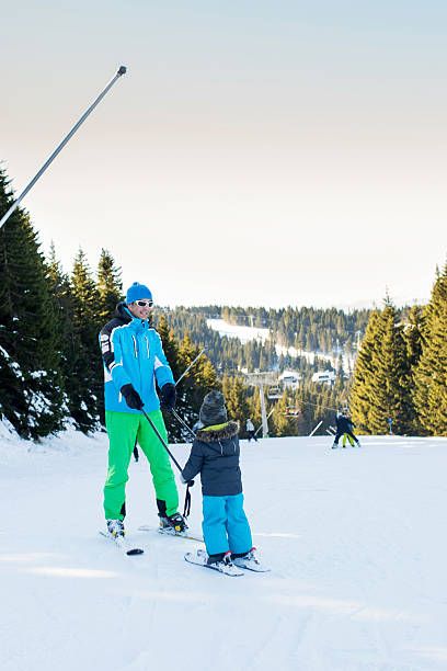 istock Ski instructor on mountain teaching child how to ski. 615104456