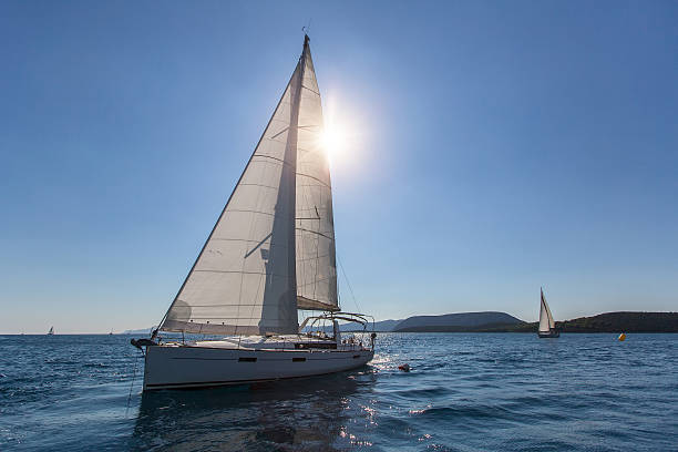 istock Sailing ship yachts regatta, shot boat against the sun. 615105462