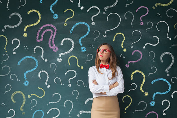 istock Businesswoman and question marks on blackboard 615107450