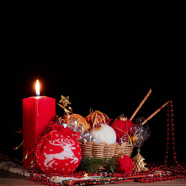 istock Christmas balls and a candle on a black background. Postcard 615107988