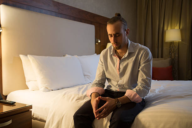 Man on the bed stock photo