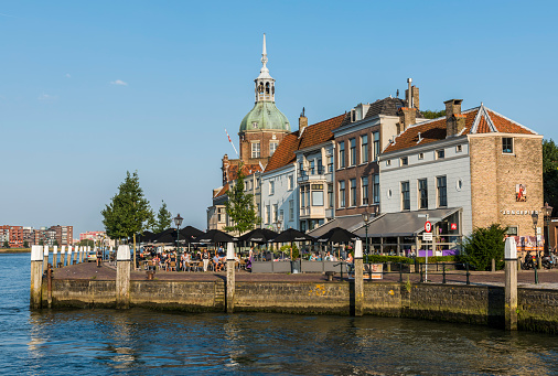 Grassland And Pier Of IJessel River Looking At St. Lebuinus Church In Deventer, The Netherlands