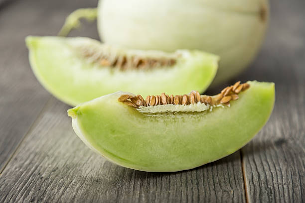 istock sliced ripe melon on rustic wooden background 615111114