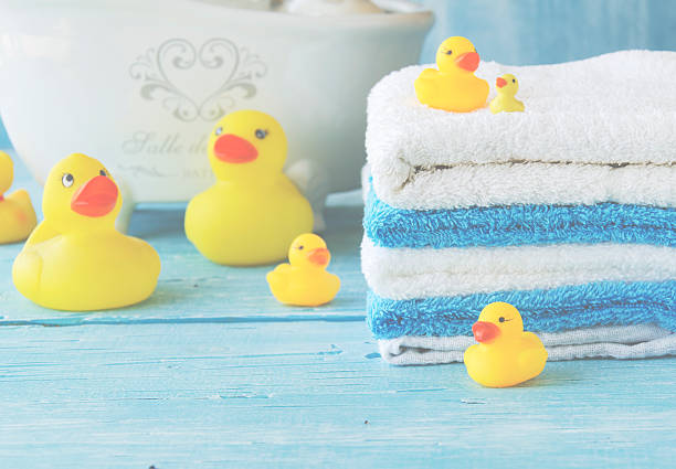 istock stack of colorful towels and bath duck on the table 615111454