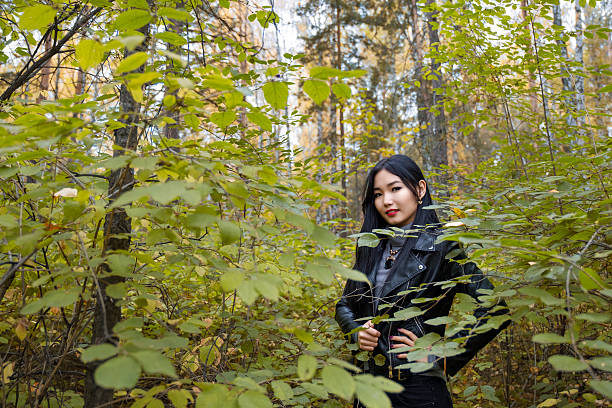 istock Asian woman poses in the park 615112332