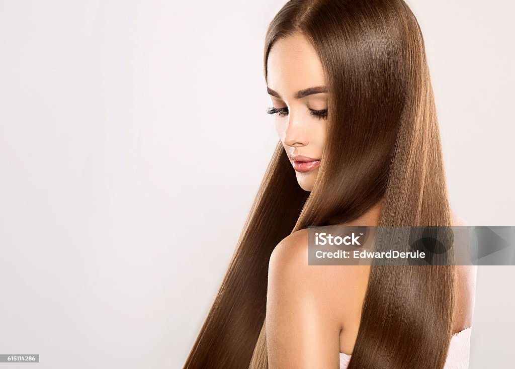 Young attractive model with gorgeous, shiny, long, straight hair. Young attractive girl-model with gorgeous, shiny, long, straight hair. Good and healthy hair as result of right care. Beauty Stock Photo