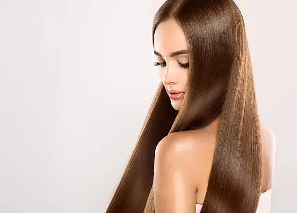 Young attractive girl-model with gorgeous, shiny, long, straight hair. Good and healthy hair as result of right care.