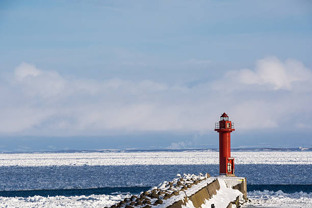 istock Red lighthouse of the winter port 615114954