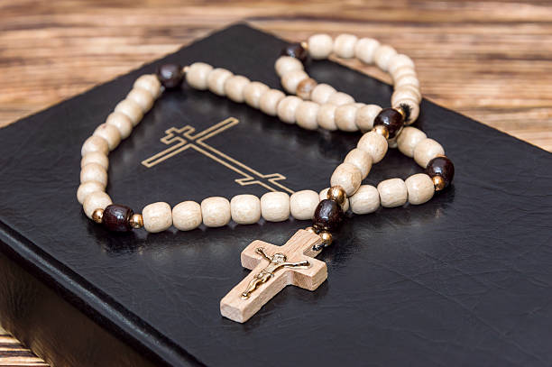 istock rosary beads on the Bible. Close up 615115392