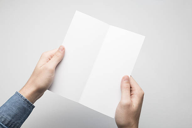 istock Hands are holding a Dl Bi-Fold white paper poster. 615116450