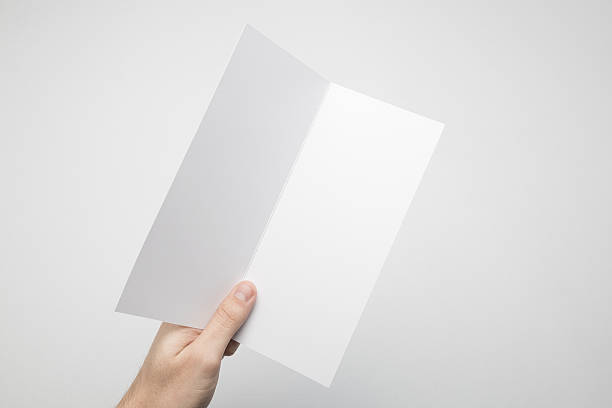 istock Hands are holding a Dl Bi-Fold white paper poster. 615116658