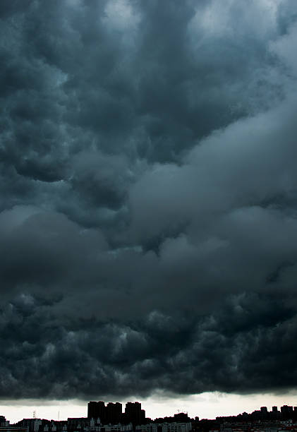 istock Dark stormy clouds over city 615117656