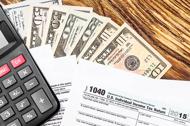 istock Calculator, tax form and money on the table 615117906