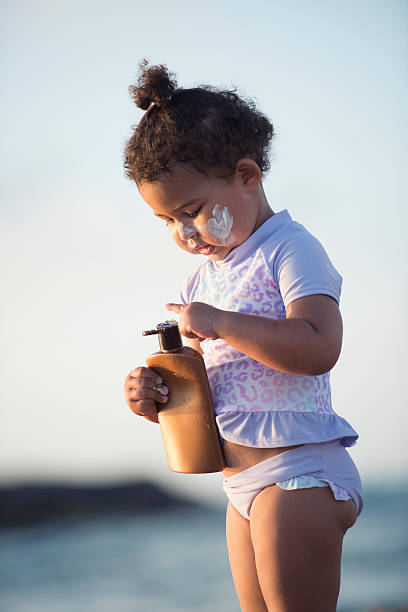 istock Baby applying sun cream protection. 615118622