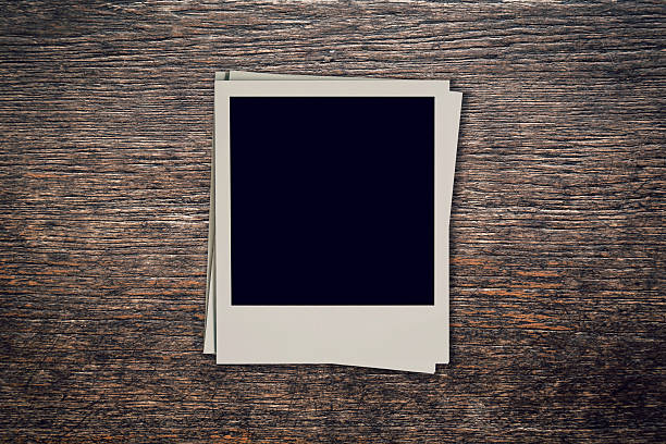istock Vintage blank photo frame on wood background with space 615119064