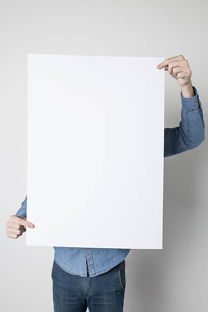 istock Man holding a white poster 615119260