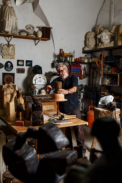 istock Senior sculptor working on his sculpture 615119350