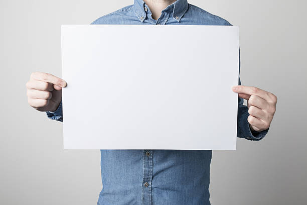 istock Man holding a white poster 615119492
