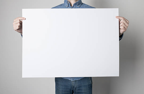 istock Man holding a white poster 615119550
