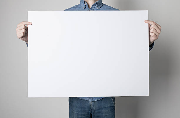 Man holding a white poster stock photo
