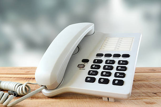 istock White telephone on wooden. 615119594