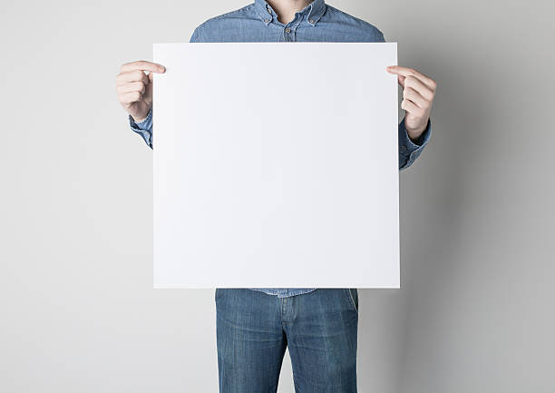 istock Man holding a white poster 615119626