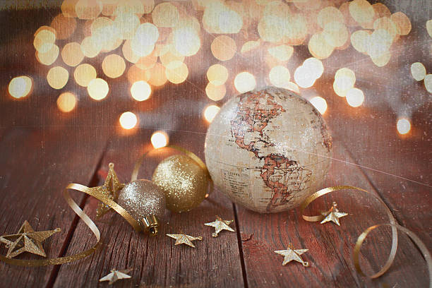 istock Environmentally Friendly Christmas Decorations and Globe on Old Wood Background 615234028