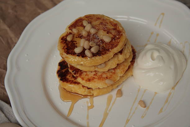 istock Russian sweet cheese pancakes with sour cream 615235404