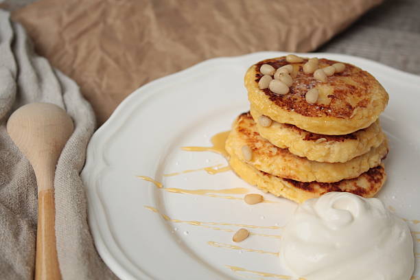 istock Russian sweet cheese pancakes with sour cream 615235462